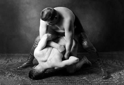 Soviet Union photographic postcard showcasing ideal male body shapes through Russian wrestlers' poses.