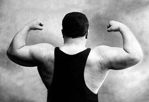 Soviet Union photographic postcard showcasing ideal male body poses of Russian wrestlers.