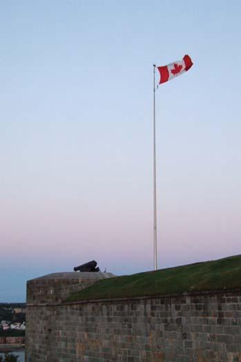 The Canadian flag waving over the ramparts of a historic citadel, poster print by Jason Pierce.