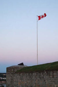The Canadian flag waving over the ramparts of a historic citadel, poster print by Jason Pierce.