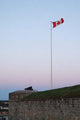 The Canadian flag waving over the ramparts of a historic citadel, poster print by Jason Pierce.