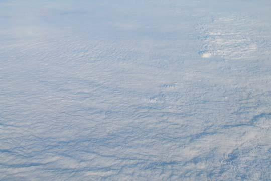 Clouds viewed from above airplane window poster print by Jason Pierce.