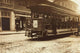 Young boy riding on the back of a trolley car poster print.