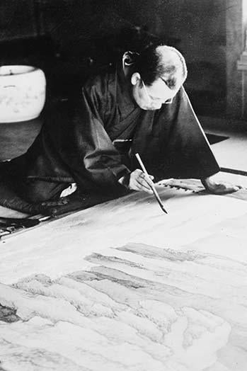 Japanese man painting with bamboo brush on large canvas poster print.