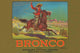 Cowboy swinging lasso from horseback on vintage crate label art print.