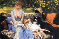 A young woman with a toddler and a dog sitting on a leopard print couch in a garden.