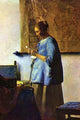 Vintage art print of a young girl reading a letter by Johannes Vermeer.