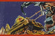 Vintage tin toy box art featuring a space tank attacking a gorilla.