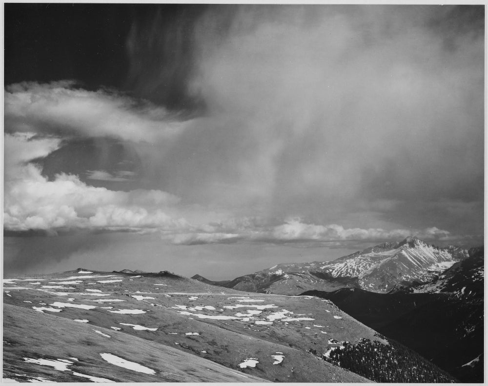 Mountain tops and low hanging clouds poster print by Ansel Adams showcasing Rocky Mountain National Park.