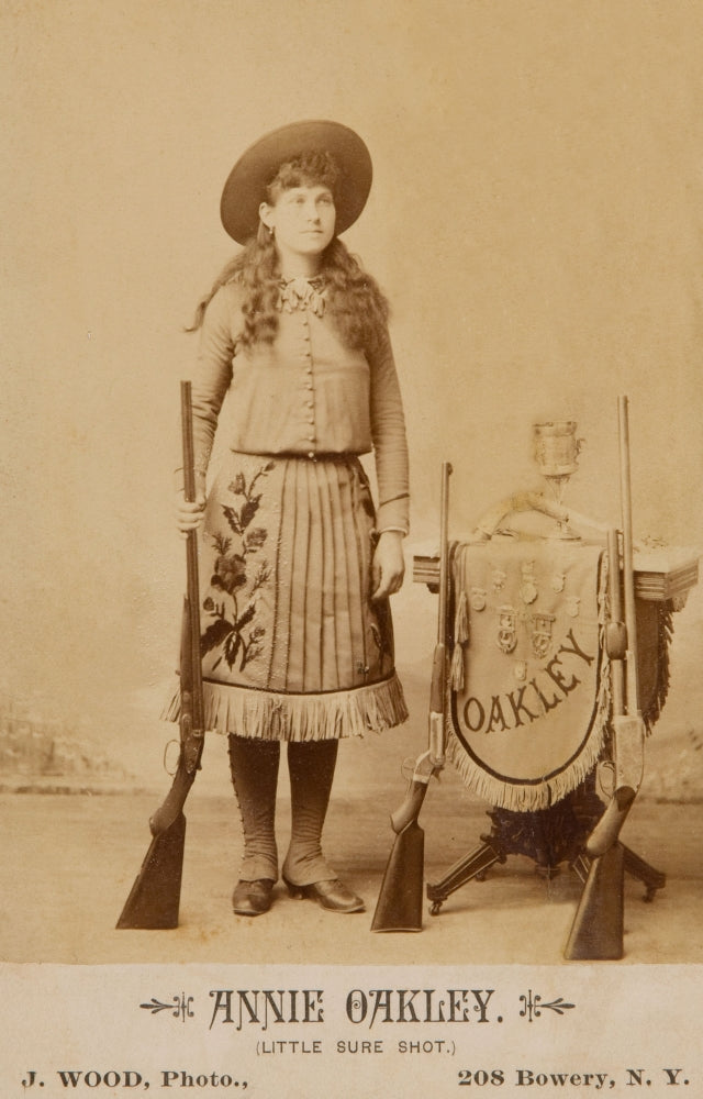 Annie Oakley Shooting Medals Poster Print featuring shotguns and rifle.