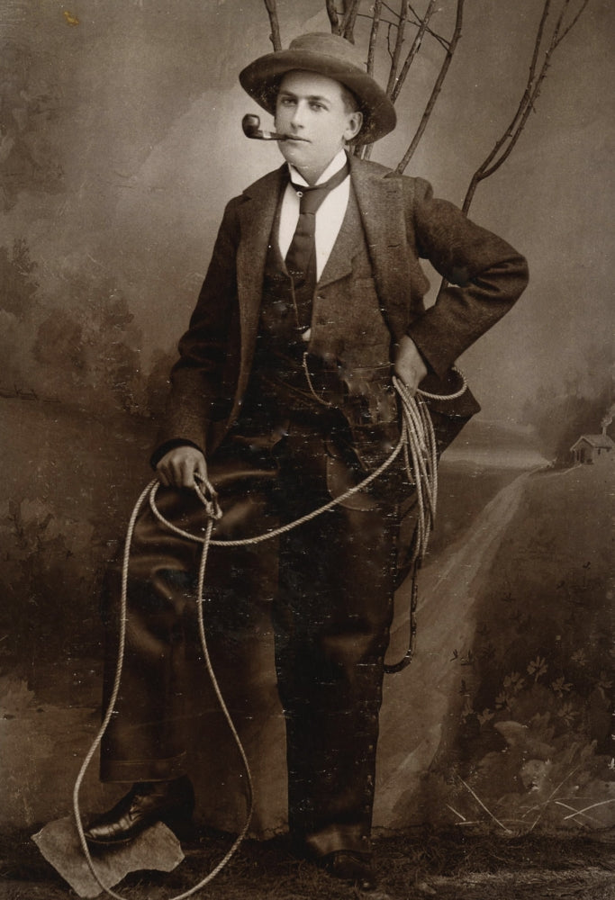 Gentleman Cowboy Poster Print featuring a cowboy in leather chaps with a Colt revolver.