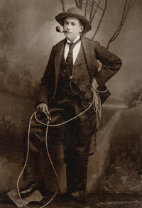 Gentleman Cowboy Poster Print featuring a cowboy in leather chaps with a Colt revolver.