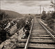 Men Sit Beside Tracks Taking Notes Poster Print on premium paper.