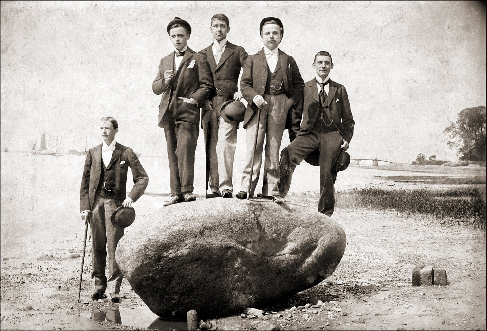 Young Men Stand on a Boulder Poster Print showcasing youth and adventure.