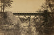 Two Trestle Bridges Over a Creek Poster Print showcasing serene natural beauty.