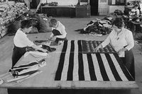 Flags laid out on cutting table for American ensigns during the Great War.