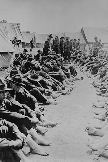 Foot Inspection Poster Print showing soldiers in uniform with bare feet.