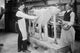 Poster print of two artists sculpting a cow for a museum exhibit.