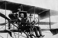 Two aviators flying an early biplane poster print