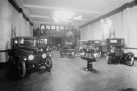 Automobiles and trucks on display under American flag banners poster print.