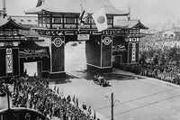 Prince of Wales Motorcade in Kyoto, Japan Poster Print with British and Japanese flags above an archway.