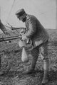 German Bomber Pilot attaching a bomb to his airplane poster print