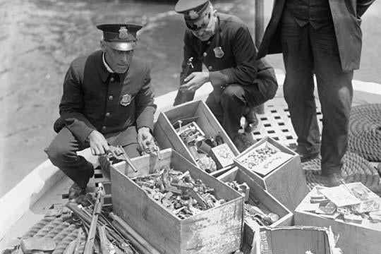New York Police Destroy Boxes of Revolvers Poster Print showcasing police action.