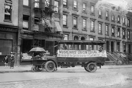 Musicians Union Truck parked by Hot Dog Vendor Cart with Transit Strike banner poster print