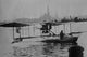 Biplane landing in the canals of Venice poster print