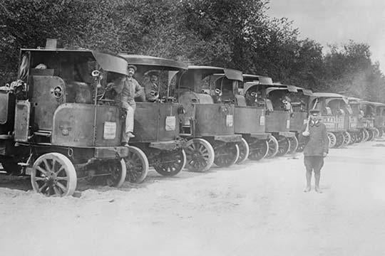 A Fleet of Trucks Poster Print showcasing military logistics with trucks and drivers ready for action.