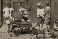 Poster print of four young children loading rocks into a wagon while a smaller child plays with a toy pony cart.