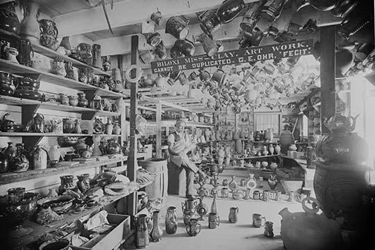 Owner Sits in Retail Pottery Store Waiting for Customers Poster Print