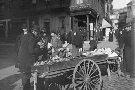 Banana Vendor Sells from Wooden Wheeled Cart Poster Print by Byron, colorful market scene artwork.