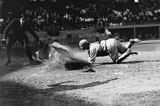 Baseball Player Dust Clouds Poster Print capturing the action at home plate.