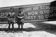 Poster print of pilots posing in front of an airplane, showcasing aviation spirit.