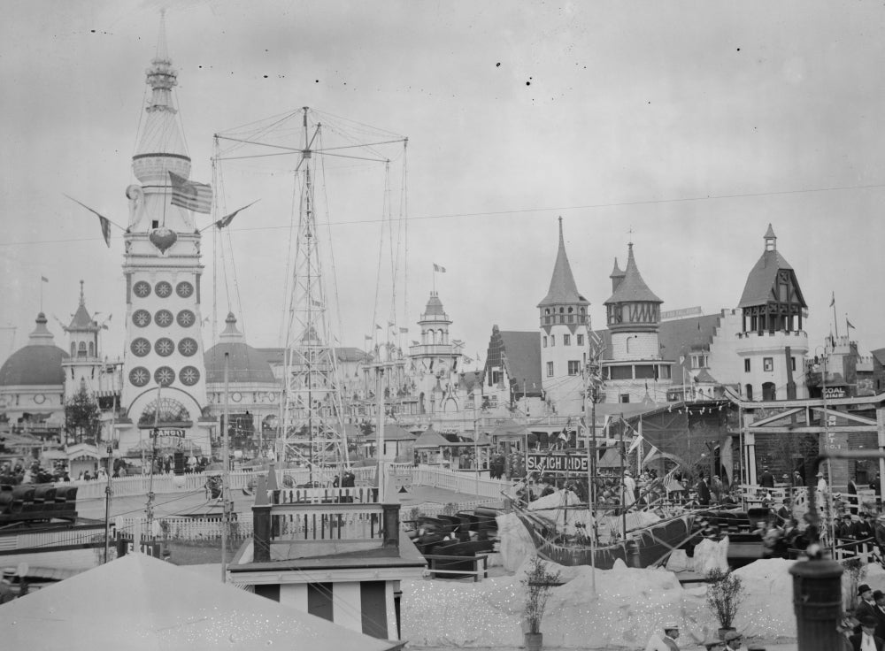 Amusement Rides at Coney Island Poster Print featuring colorful rides and a fun atmosphere.