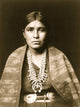 Head-and-shoulders portrait of a Navajo woman, showcasing Indigenous beauty and culture.