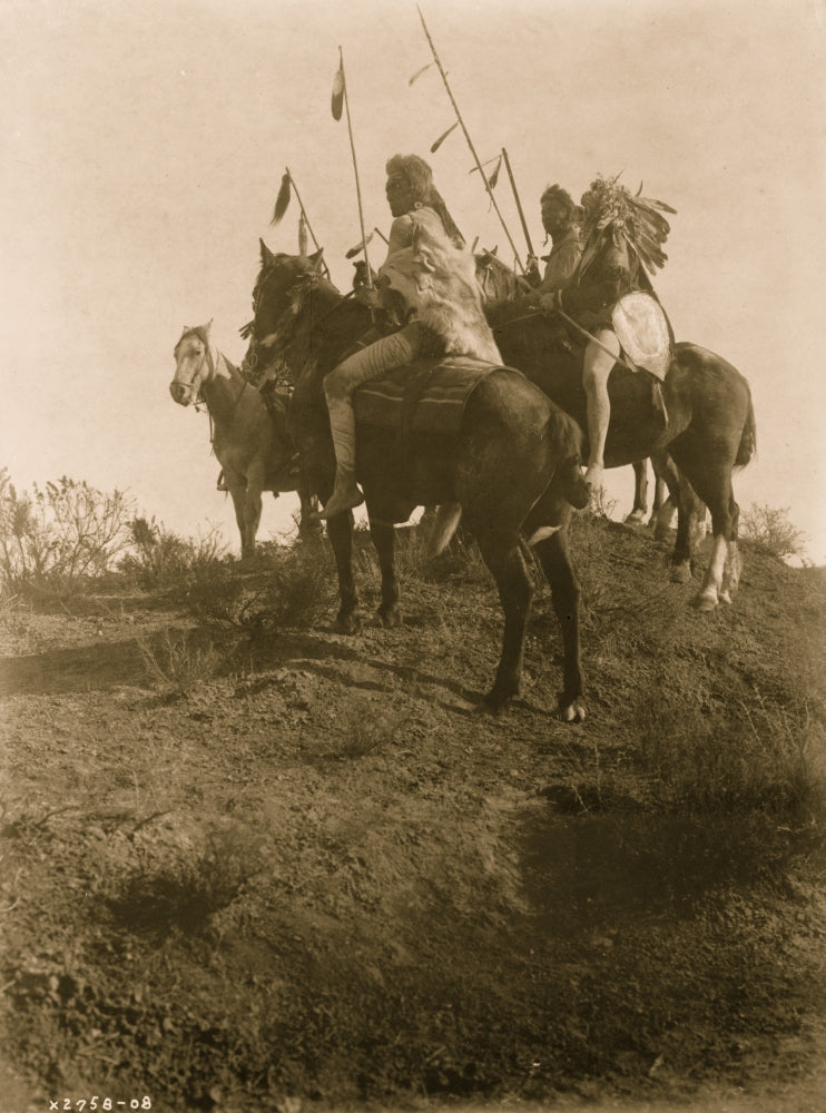 Four Crow men on horseback holding feathered spears poster print