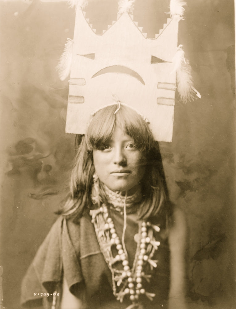 Head-and-shoulders portrait of a woman with an elaborate tablita headdress.