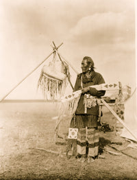 Blackfoot man full-length portrait poster print standing in a field holding decorated sheaths.