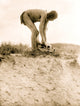 Man in breechcloth bending over buffalo skull poster print.