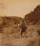 Three Apache people riding pack horses along rocky terrain poster print.