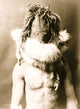 Indian half-length portrait poster print featuring a dark mask and fur ruff.