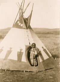 Piegan girl wearing beaded buckskin dress in doorway of tepee, Montana.