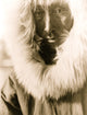 Portrait of an Eskimo man wearing a fur-lined parka.