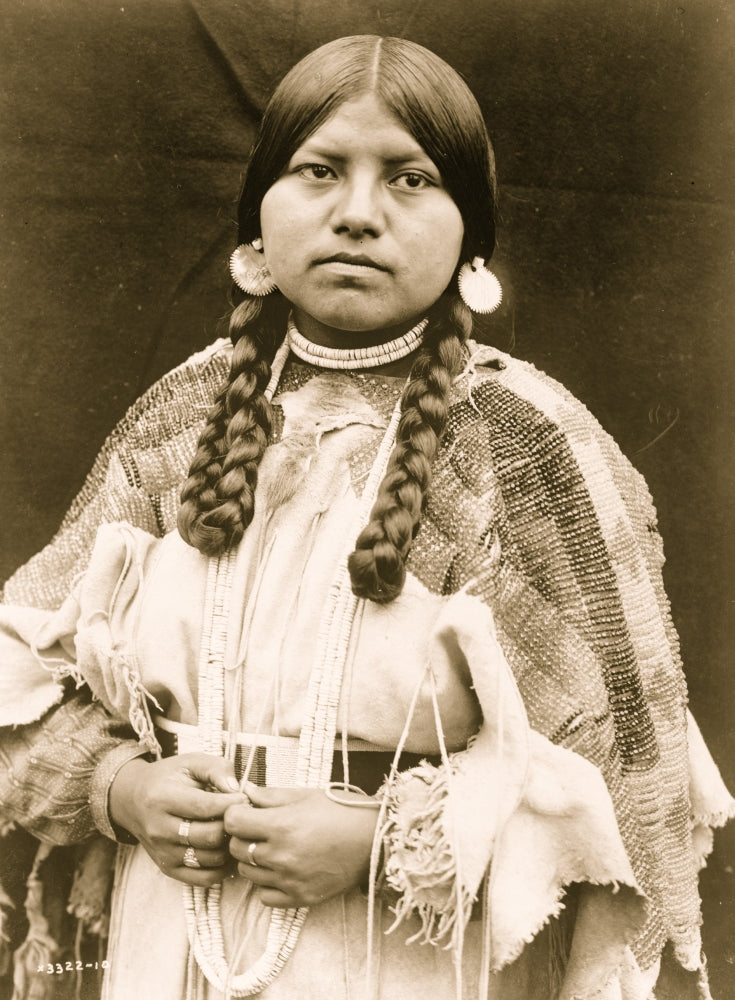 Cayuse woman portrait featuring braids, shell earrings, and beaded dress.