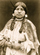 Cayuse woman portrait featuring braids, shell earrings, and beaded dress.