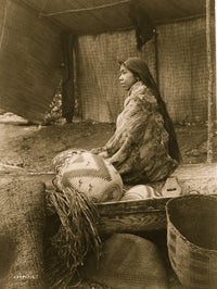 Half-length portrait of a Skokomish Indian chief's daughter seated in a canoe.