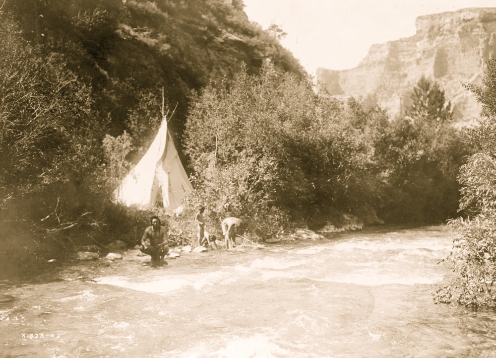 Crow man with two children at river's edge poster print surrounded by trees and mountains.