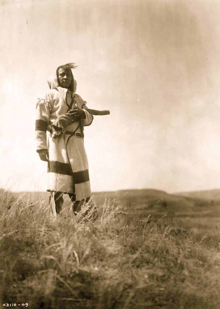 Piegan man standing with open prairie in the background poster print